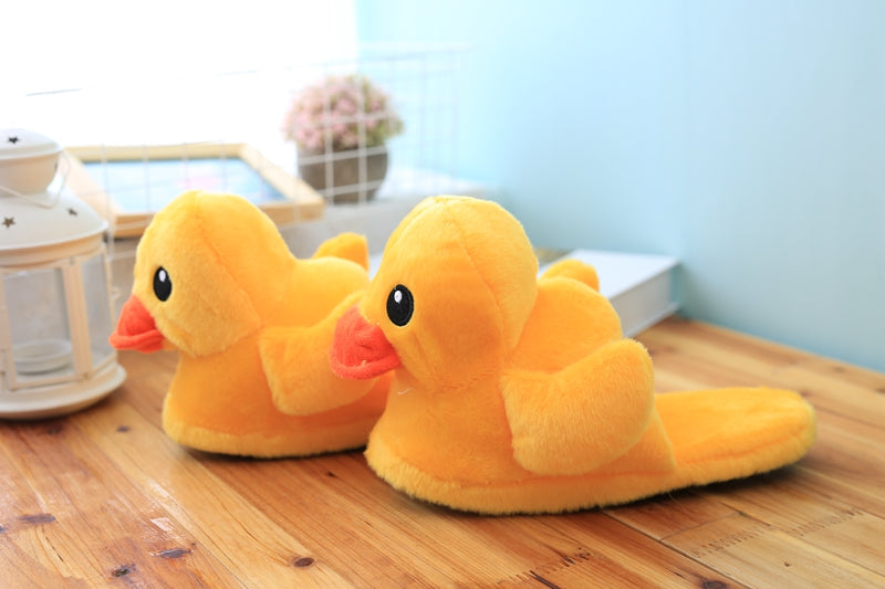 Plush animal slippers in shape of a duck for indoor use