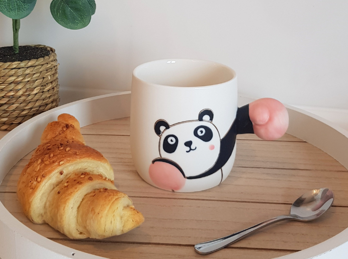 BOXING BEAR MUG. A funny gift for any occasion. White mug with a panda drawn on it and as a holder it has the arm of the panda extended, with a pink glove, as if it was boxing. Bear is looking focused.